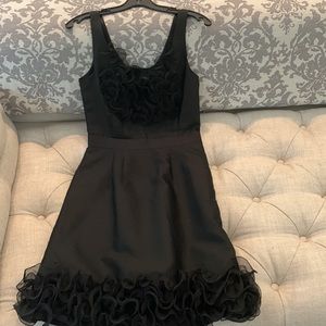 Black Kate Spade cocktail dress with frilly ruffle detail at hem & neckline.